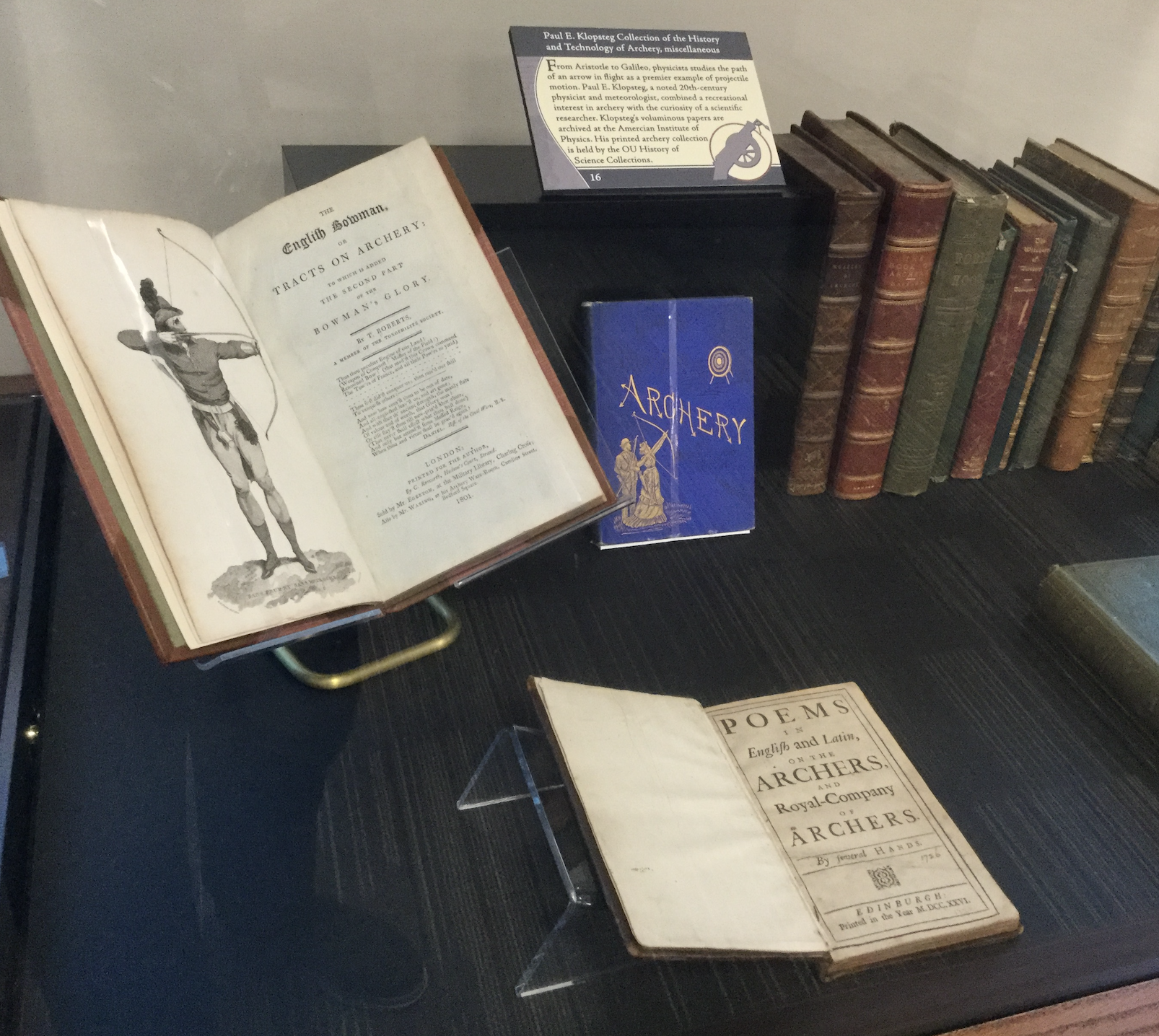 Photo of books in display on table; some opened, some with covers, some with spines showing