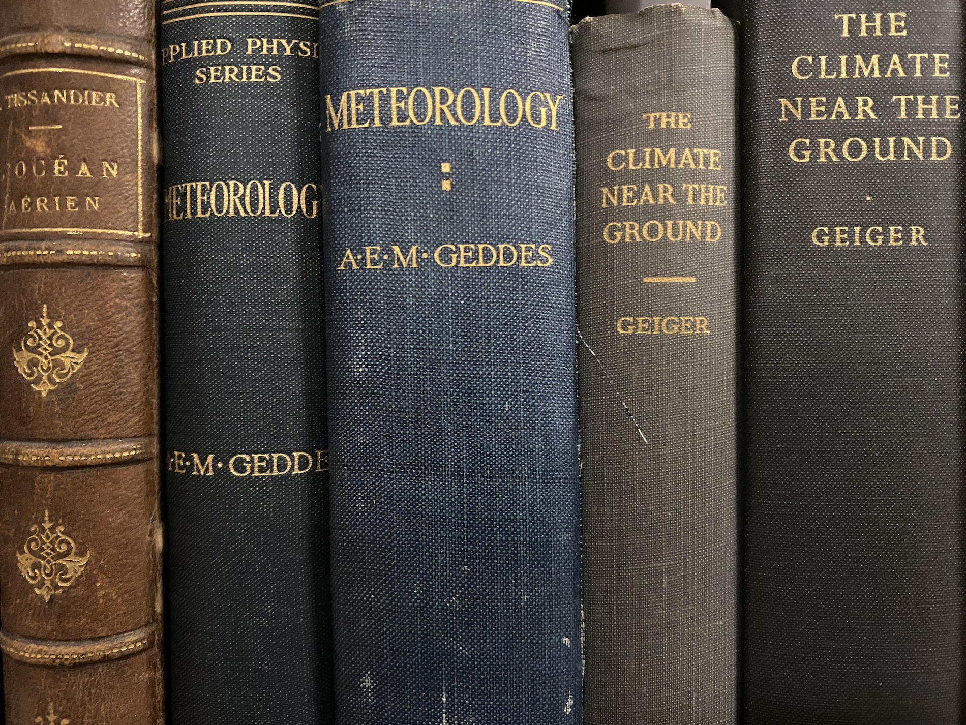 Photo of shelf of books (mostly 19th books with spines visible)