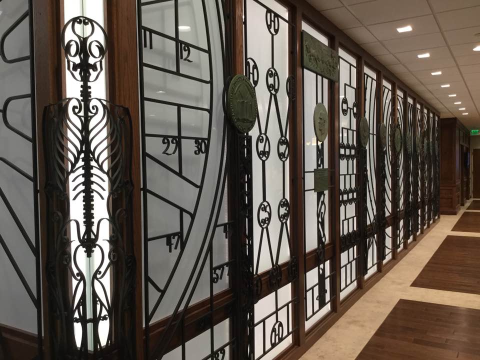 Photo of ironwork screen with scientific and medical images including skeleton