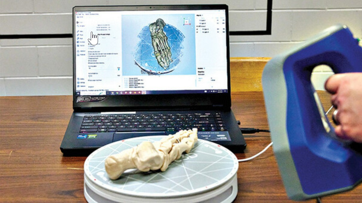 3D scanning in action. The Artec Spider is shown scanning foot bones on a turntable