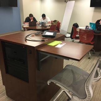 Instructor podium with students in the background