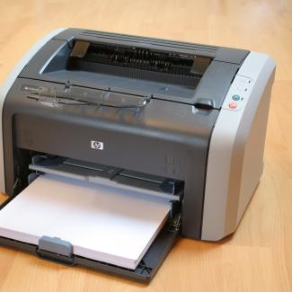 Printer with paper on table
