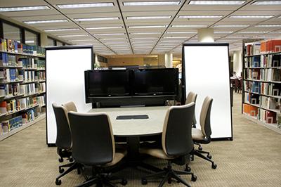 A desk surrounded by bookshelves full of books